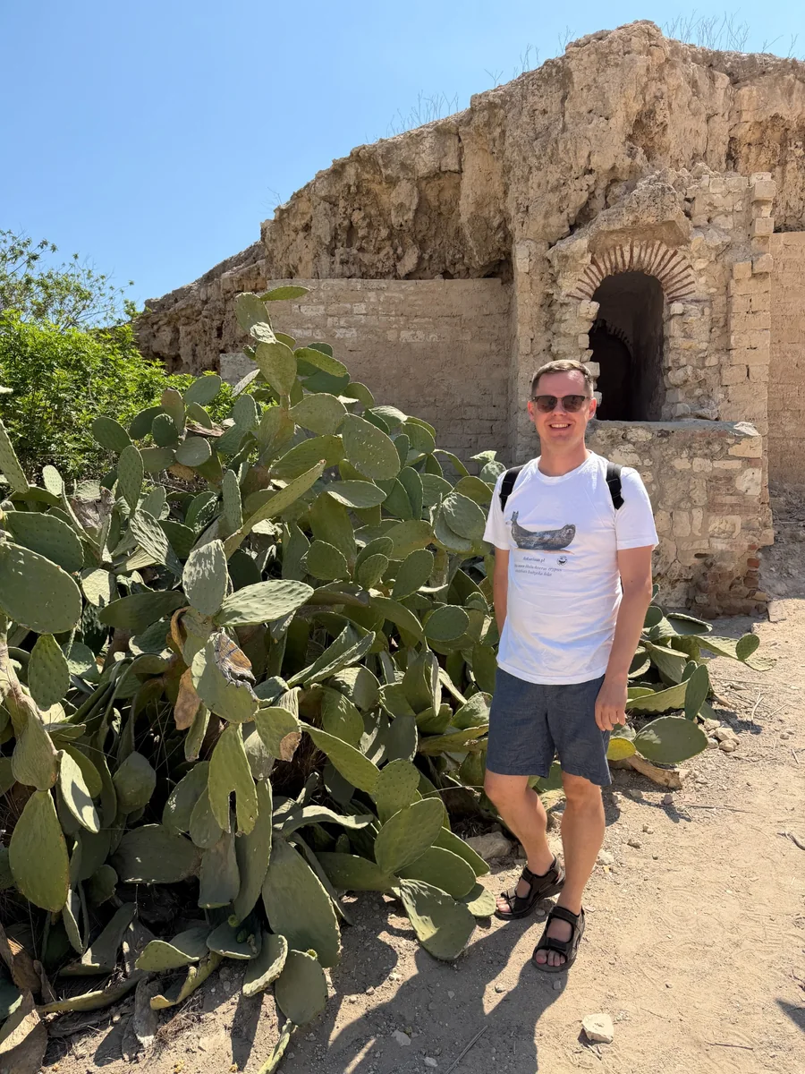 Konrad Szychowski beside an opuntia while travelling.